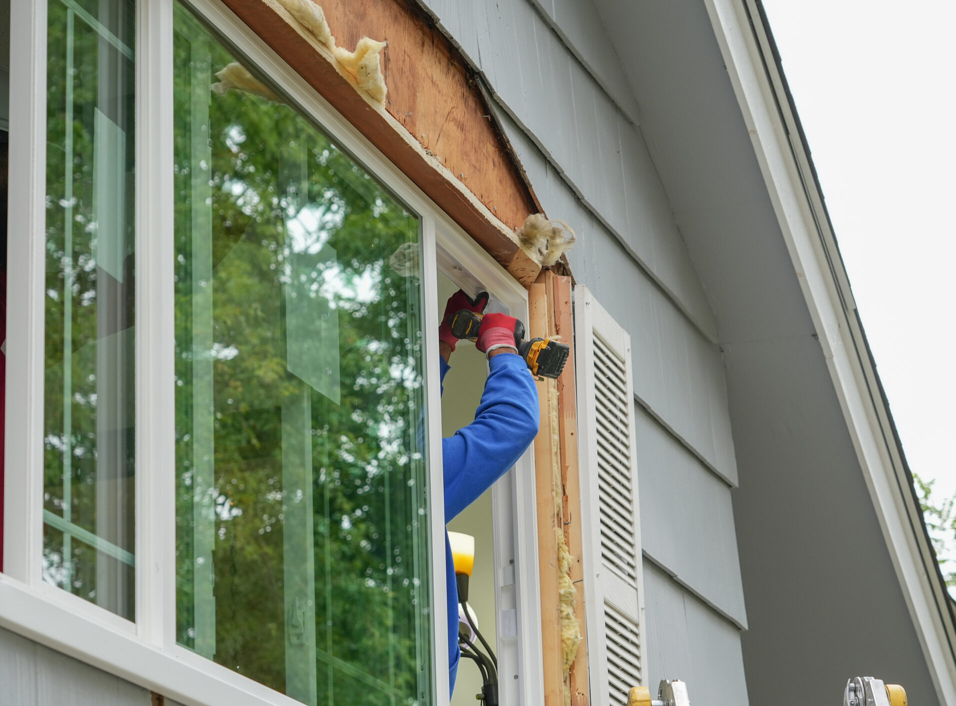 contractor working on replacing the window of the house